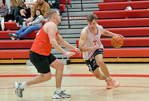 The Class of 2022/23’s Preston Ramaekers dribbles past 2018’s Ian Boerkircher during the Aurora alumni tournament final Sunday as 22/23 ended the winning run of 2018, 43-22. 