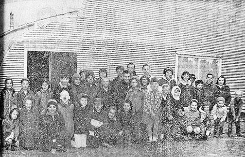 School children from the Phillips School next door pose in front of the original Phillips Memorial Hall in February 1966 the day after it was damaged by fire. Lifelong Phillips resident Jim Ratchje is one of those pictured and he remembers the event not only because he was allowed to go inside and see the fire damage, but also because his younger sister was born the same night. This photo appeared in the following week’s edition of the Aurora News-Register.  