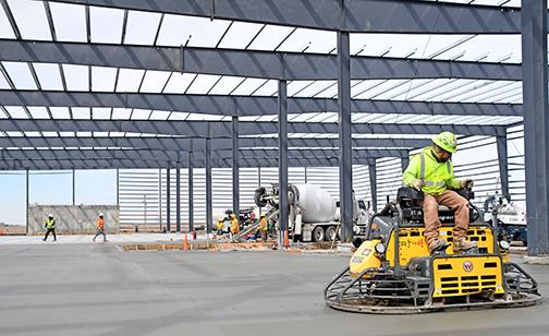 A crew works on pouring concrete at the Special Ag Formulations plant under construction in Aurora. 