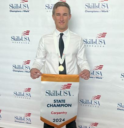 Connor Smith displays the State Champion banner he won at the SkillsUSA collegiate competition in Grand Island on April 13. He is now preparing for the national competition in Atlanta, Ga. in June. 
