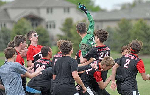 Aurora celebrates after Rylan Bartek (one finger up) stopped a pair of York penalty kicks to give the Huskies a 4-3 win over the Dukes Saturday in the B-7 subdistrict opener. 