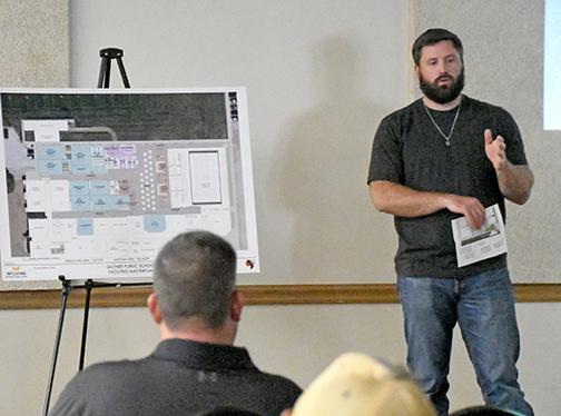 Giltner school board member Nathan Most describes the location of new locker rooms in the high school gym at Monday night’s school board meeting.