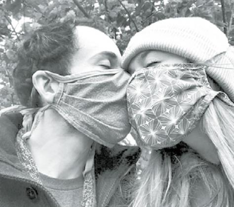 Erin Whitney shares a nose bump through safety masks with her boyfriend, Asher Ben-Or Whitney works in real estate in New York City, where she said people are both leaving and moving in during this pandemic. Courtesy photo