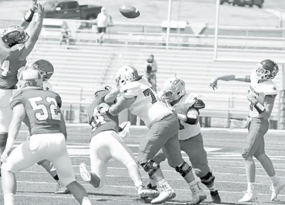Ryan Marlatt lays a crushing block on a pass rusher during Saturday’s 62nd annual Shrine Bowl game played at UNK. News-Register/Richard Rhoden