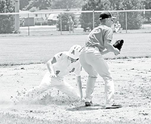 Pinnacle Bank White’s Layton Hohm slides in safely to third base. News-Register/Richard Rhoden