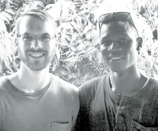 Daniel Heiser of Aurora, left, shown here with his Gambia “twin brother,” Malik. Courtesy photo