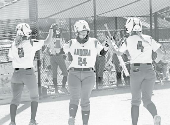 Kaleigh Metzger (middle) high fives teammates Kylie Larson (8) and Zarian Arends after both of them scored during a 13-2 win over St. Paul Friday. News-Register/Richard Rhoden