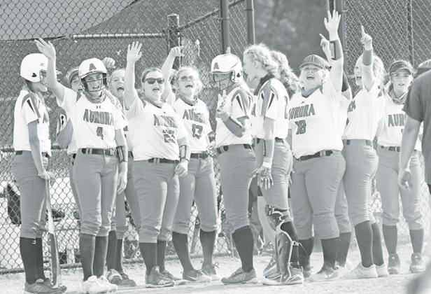 Instead of the traditional shaking hands at the end of the game, the Aurora softball team waved to its opponent from its dugout after each contest Friday. News-Register/Richard Rhoden
