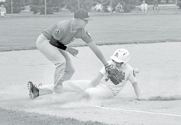 Pinnacle Bank White’s Layton Hohm slides into third base, arriving just before the ball as Aurora Cooperative Red’s Kyle Larson looks to make the tag. News-Register/Richard Rhoden