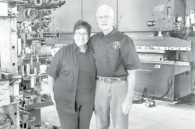 Jim and Kay Lindquist stand in the midst of equipment at their Giltner blacksmith shop. Jim founded the company in 1969 and Kay joined him as business manager in 1991. News-Register/Kurt Johnson