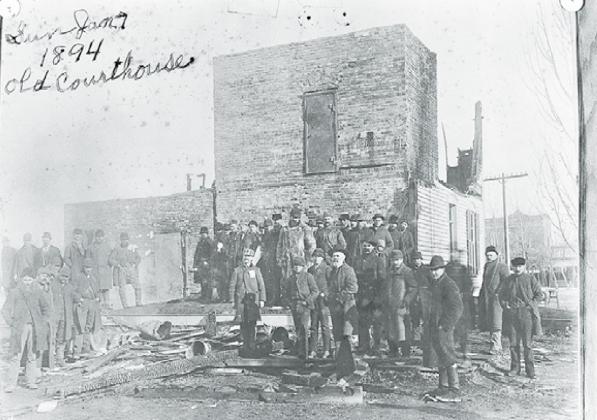 This photo, found in the archives at the Plainsman Museum, shows a large group of unnamed men standing outside the burnt remains of Hamilton County’s second courthouse. This building burned to the ground on Jan. 7, 1894. Photo courtesy of the Plainsman Museum