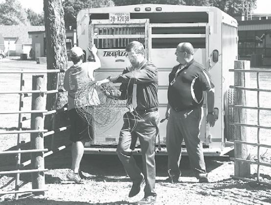 From left, Dylan Bamesberger, Hampton High School Principal Brad Feik and ag instructor Joel Miller get ready to unload five head of cattle into the newly built Hawk farm located just west of the football field. News-Register/Kurt Johnson