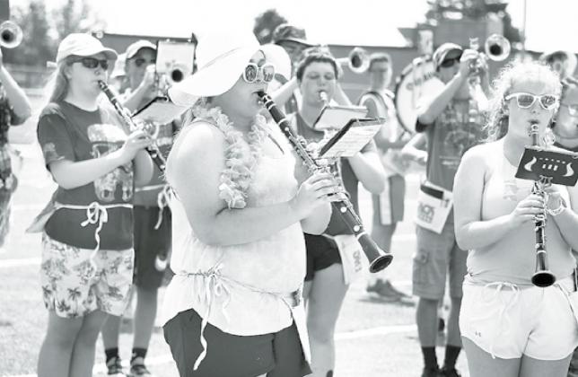 Aurora marching band members spent Thursday charting out a few of their songs. The “beach day” theme was brought to life with festive outfits, and a rather hot and humid climate. From left, seniors Callie Gaskill and Journey Thornbrugh look cool in their shades. News-Register/Cheyenne Rowe