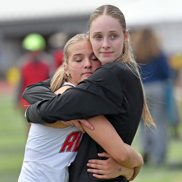 Stella Peterson (left) and Kaitlyn Staehr hug it out after finishing fifth and second respectively in Thursday’s triple jump event. 