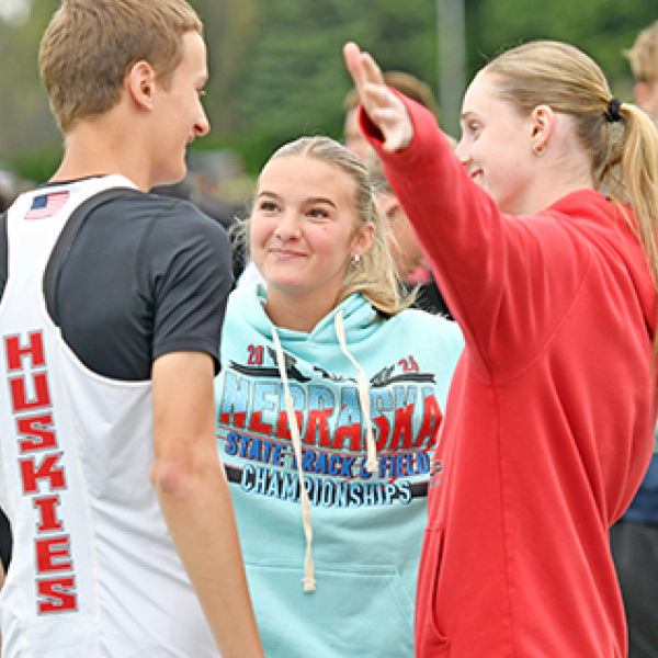 Following his final jump as a Husky Thursday morning, Jayden Slagel was embraced by fellow Husky jumpers Stella Peterson (middle) and Kaitlyn Staehr.