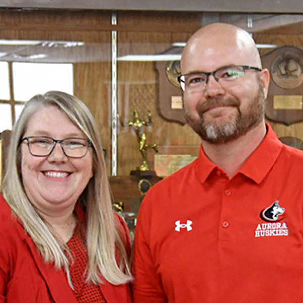 Nebraska School Counselor Association Executive Director Malinda Jean Baptiste congratulates Aurora High School Counselor Jacob Willems after naming him as the Nebraska School Counselor of the Year for 2026.  