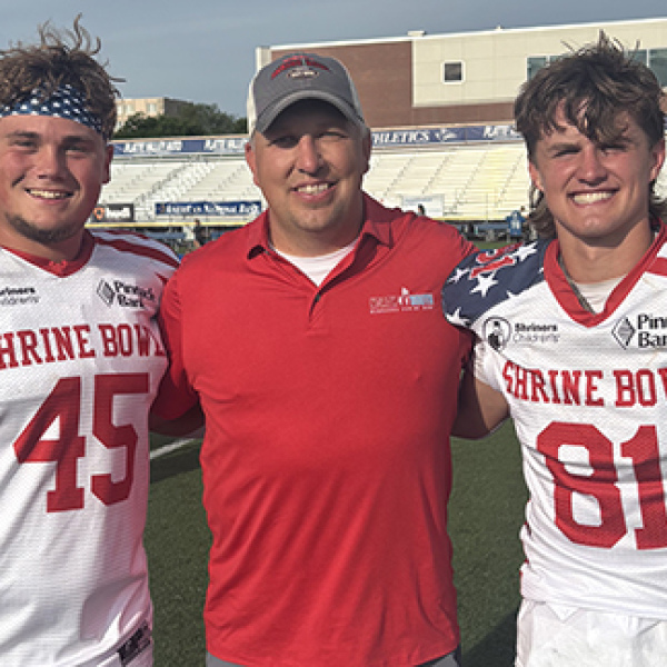 Wade Miller, a 2002 Aurora graduate now serving as an assistant coach in Seward, was an assistant coach for the South team in Saturday’s Shrine Bowl. He celebrated after the game with former Huskies Collin Stolpe and Canon Allen.