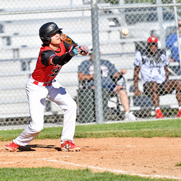 Keagan White lays down a bunt during Aurora’s win over Gering. White had three RBIs in the win. 