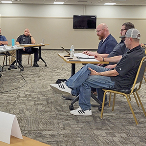 Members of a citizens focus group (seated at center table) present their findings during a report to the Aurora City Council at a May 26 meeting which drew approximately 40 people to the Bremer Center.