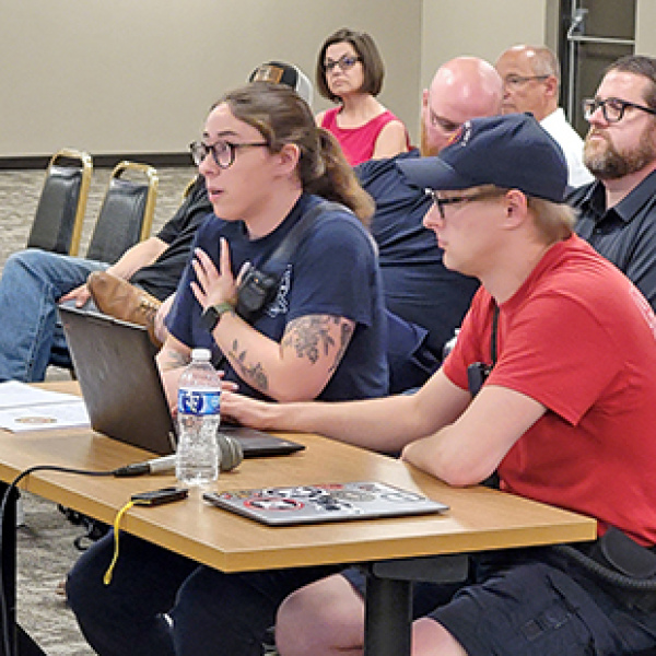 Amelia Guenther, left, and Chris Hyde address the Aurora City Council during last week’s meeting, where the local firefighters union made its case as to why Aurora’s ambulance service should remain public, not go private.