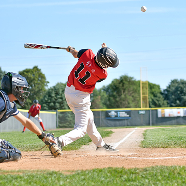 Jack Carstensen connects with one down the left field line duirng a game earlier this season for the Aurora Cooperative Juniors team. 