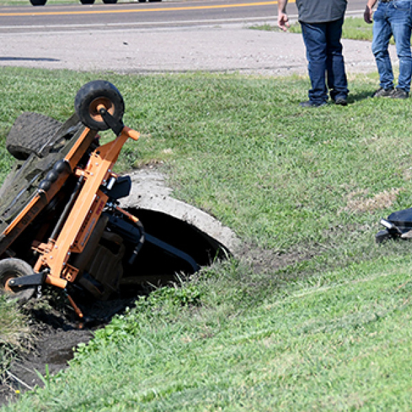 This mower operated by a Hampton maintenance worker came to rest near this culvert Tuesday after it was struck by another vehicle.