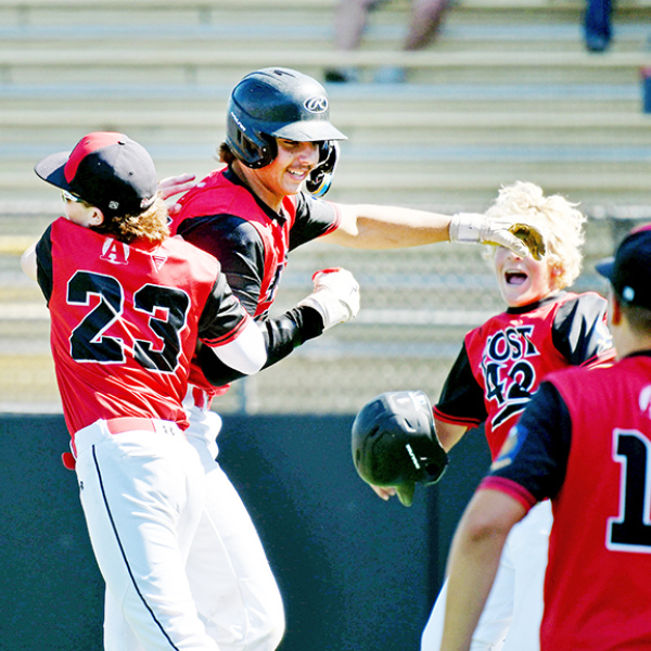 Sawyer Kiner (middle) celebrates with his teammates after launching a three-run homer to lift the Aurora Cooperative Post 42 Juniors team to a 5-1 win over Central City at the B-4 district tournament in York Monday. 