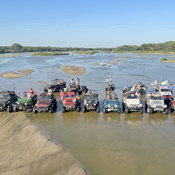 The water level in this picture of a group of River Rats enjoying a day on the river is almost too low for maximum jeeping enjoyment, according to River Rats President Jake Brown. He says members like a water flow of about 1,200 cubic feet per second so that riders can be in the water to cool off on a hot day. 