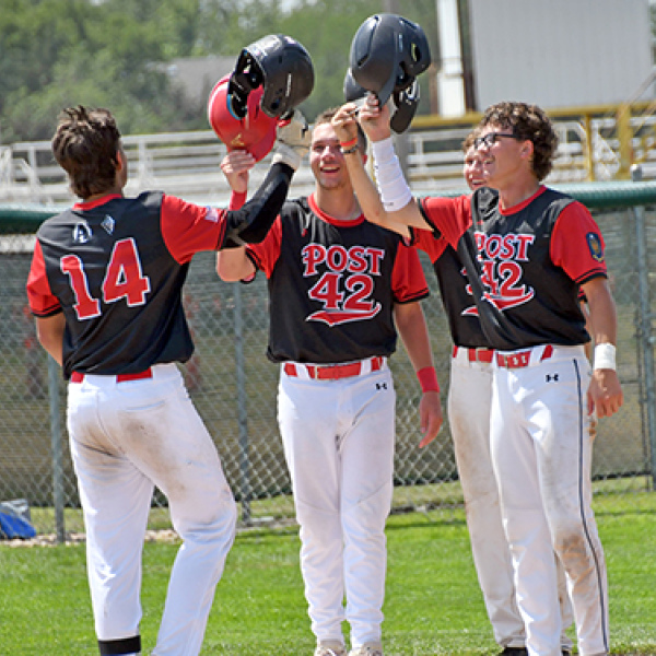Sawyer Kiner is met at the plate by Jace Dorsey, Jack Carstensen and Lukas Fry after his grand slam during Aurora’s 13-5 win over Overton in Saturday’s elimination game at the Area 6 tournament in Holdrege. 