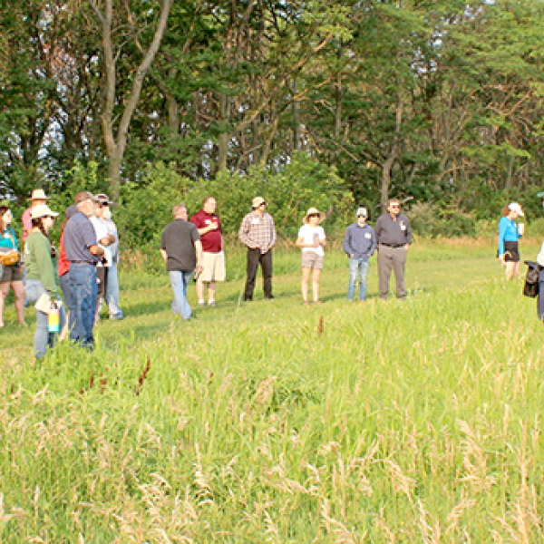 David Vetter (right), CEO of Grain Place Foods, leads a tour of the organic farm near Marquette during a Field Day in 2023. Tours of both the farm and the processing facility will be part of the morning session of the 2026 Field Day on July 18. 