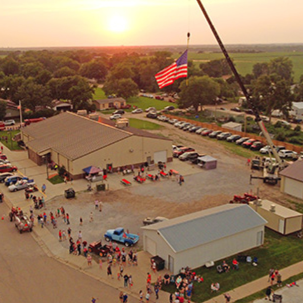 Old Glory flies high above the Phillips Memorial Hall Friday evening as the community came together to celebrate America’s 250th birthday. 