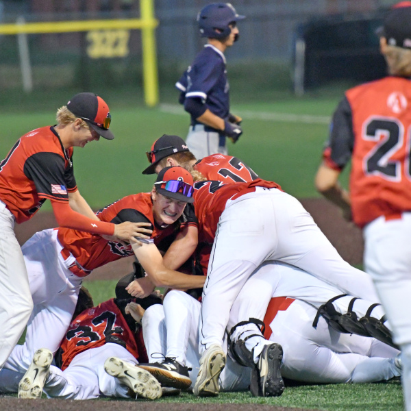 The Aurora Cooperative Post 42 Juniors team celebrate after winning the Class B Area 4 district championship Tuesday night in York. 