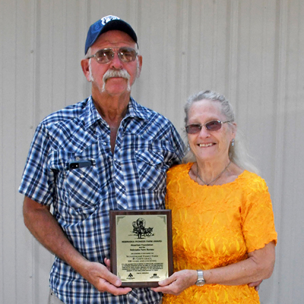Larry and Jane Nunnenkamp of southern Hamilton County display the Nebraska Pioneer Farm award they were presented with at this year’s Hamilton County Fair. Their property, situated east of Highway 14 near County Road 4, was first purchased by Larry’s grandfather, William “Bill” Nunnenkamp in 1926. 