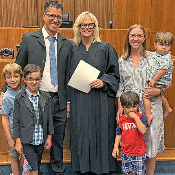 The Edwin Gomez family poses for a picture with Federal Judge Susan Bazis following the July 17 ceremony in Lincoln in which Edwin and a group of others were sworn in as U.S. citizens. Included in the picture are Gomez’s wife, Allie (Mitchell) and their four sons, from left: Benji, Zeke, Eliseo and Zeb. 