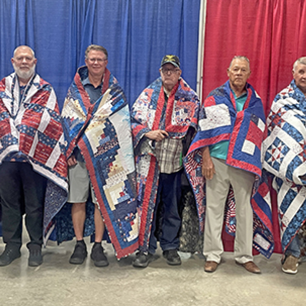 Seven Hamilton County veterans were honored with Quilts of Valor at the Hamilton County Fair on Sunday. Pictured from left are James Garfield, Barry Horner, Jim R. Nachtigal, Harold Skidmore, Arlie Johnson, Dale Quick and Cody Quick.