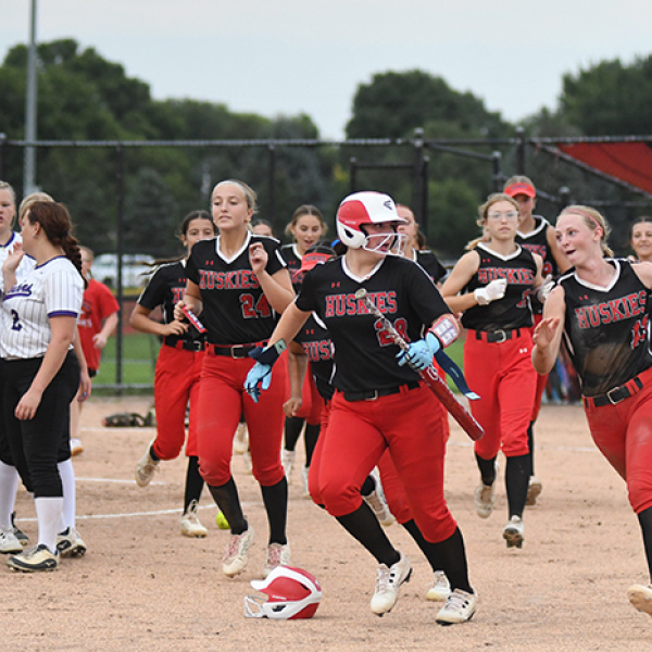 Vivi Fahrnbruch, right, and her teammates prepare to celebrate after a run-rule victory over Fillmore Central. In Aurora’s four games last week, the Huskies plated 49 runs, all victories. 