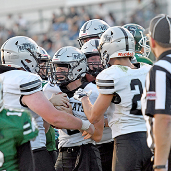 H&H quarterback River Glinsmann is mobbed by his offensive linemen after scoring a rushing touchdown in a 43-0 win over Schuyler Friday night. 