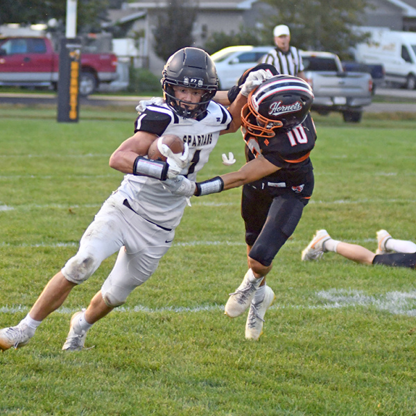 Ben Gordon wrestles down Ansley-Litchfield’s Owen Brott during Giltner’s 44-38 wild Homecoming win Friday. Gordon had seven tackles in the game that featured a three-hour weather delay. 
