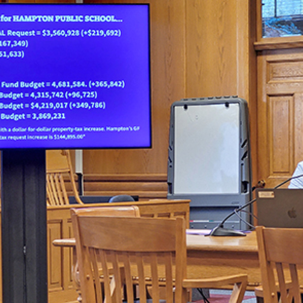 Hampton School Supt. Carson Klute explains the reasons for the districts 2026-27 property tax asking increase at a public hearing Monday night. 