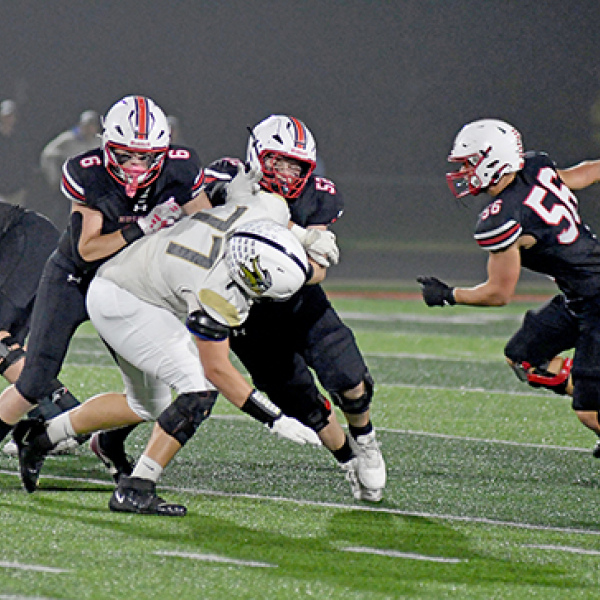 The offensive line cleared some huge holes Friday against Grand Island Northwest, as shown here with Dylan Ronnau (6) and Jake Molliconi (52) taking Aidan Deneui out of the play. Ryan Carlson (56) is shown at right looking for someone to block.