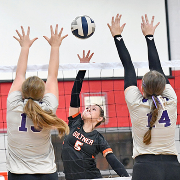 Giltner’s Reese Rudy splits two Axtell blockers as the Hornets downed the Wildcats in two sets last week. 