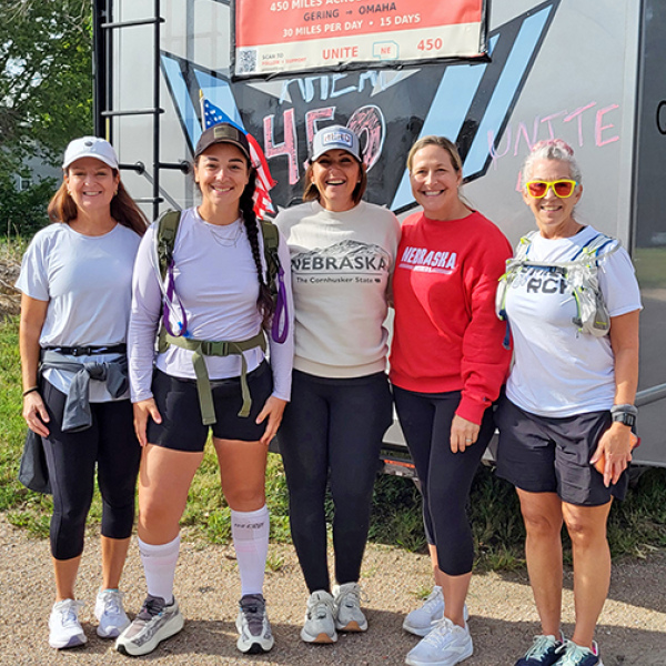 Army veteran Kerry Chester was in Hamilton County last week on her 450-mile walk across Nebraska to raise money and awareness for her organization, Unite NE 450. Joining her for her hike on the Dark Island Trail last Tuesday were Holly Herzberg of Aurora and Hampton native Jodi Jefferson. Pictured from left during a break in Marquette are Herzberg, Chester, Jefferson, Shellie Gomes and Penny North. 