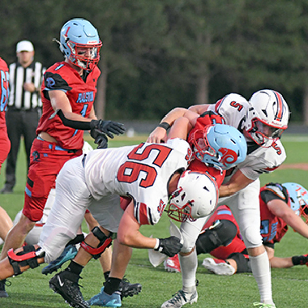 Aurora senior Ryan Carlson made his season debut Friday, getting in on an assisted tackle here with teammate Wyatt Pollet.
