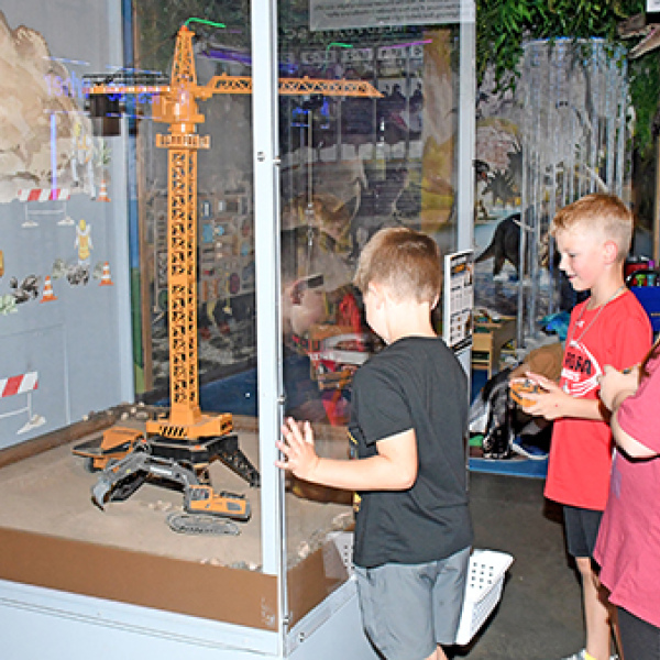 Visitors can move toy vehicles using remote controls in one of the exhibits in Edgerton’s new Build Zone. Pictured from left are Hayes Beins, Calvin Shannon and Destiny Almont.