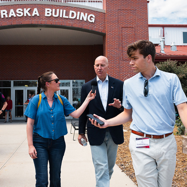 Jesse Harding Campbell, pictured at left, conducts an interview with Sen. Pete Ricketts while walking through the Nebraska State Fair. Campbell, founder of Marsh Wren Creative, recently moved with her family to the rural Phillips area.
