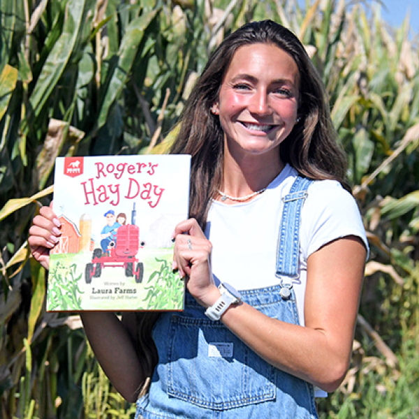 YouTube creator Laura “Laura Farms” Wilson displays her children’s book, “Roger’s Hay Day” that will be released next month. The book was created in collaboration with FFA to introduce young children to different fields in agriculture. 