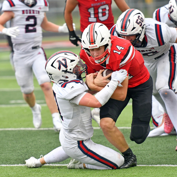 Sam Jones runs through a Norris defender during Aurora's 30-21 win Saturday afternoon. 