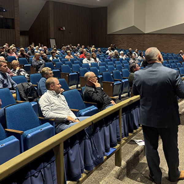 Aurora Supt. Jody Phillips, right, looks toward the screen as he explains details of a proposed $84 million school bond issue to a community group attending Monday’s information session. A similar session is scheduled for Nov. 4, beginning at 6:15 p.m. at the Middle School Theater.