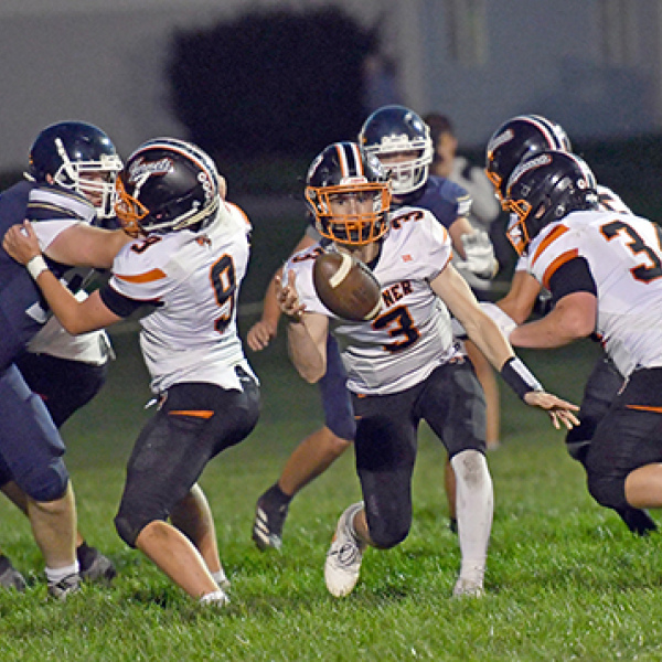Giltner QB Brody Rudy pitches the ball on an outside run play near the goal line during the Hornets’ 62-50 loss at Grand Island Lutheran Thursday. 