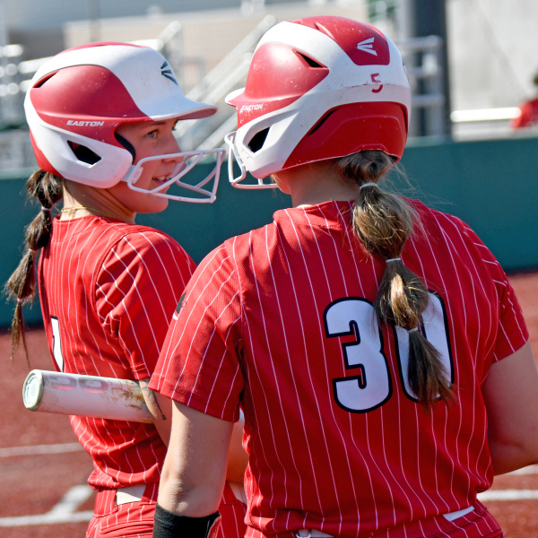 Londyn Teahon (1) and Makaylah McCartney chat before their at-bats during Aurora's loss to York in Thursday's district contest. 